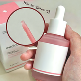 Medicube PDRN Salmon Peptide Skin Essence in a hand, showcasing the dropper and essence texture.