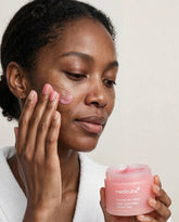 Woman applying Medicube Collagen Jelly Cream on her face for hydration and glow.